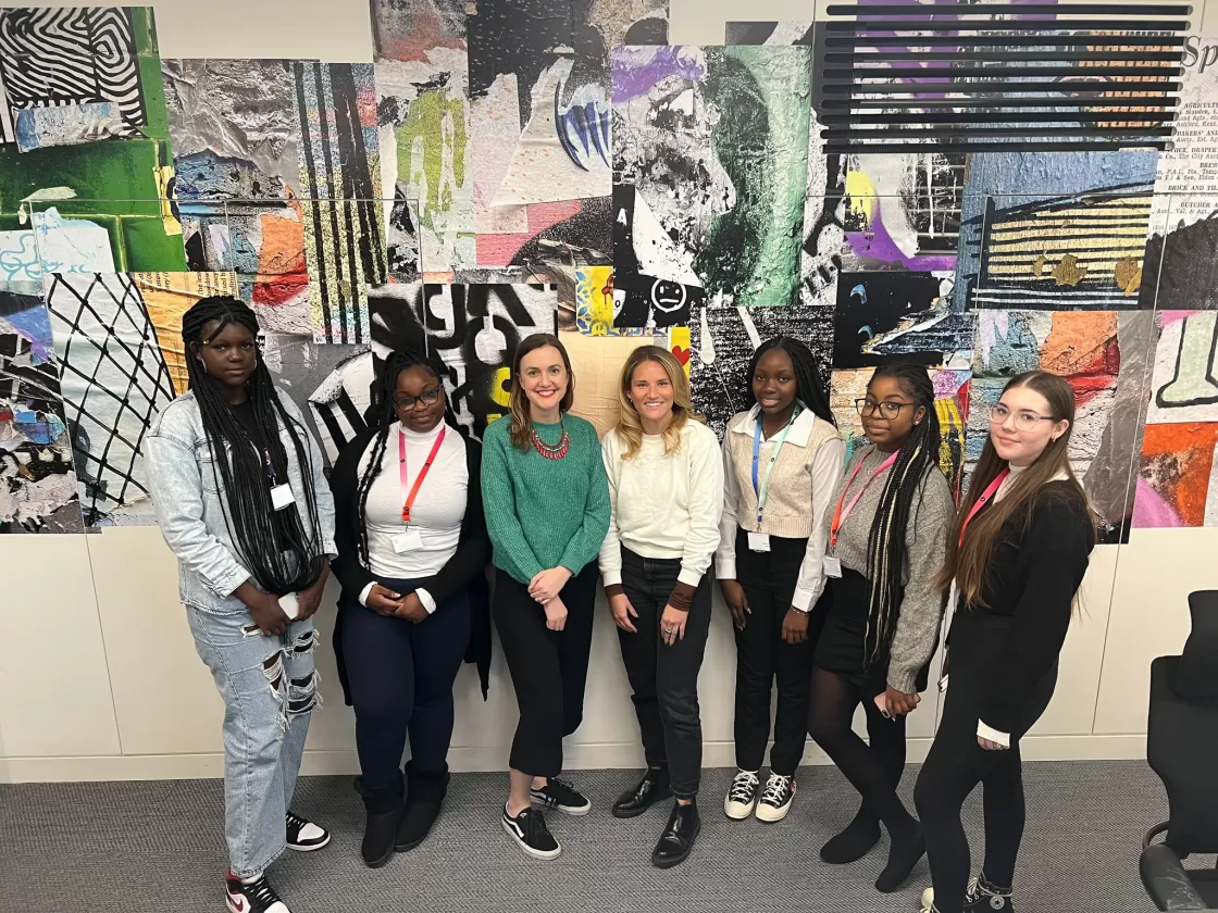 Four girls and two women at a tech work experience placement